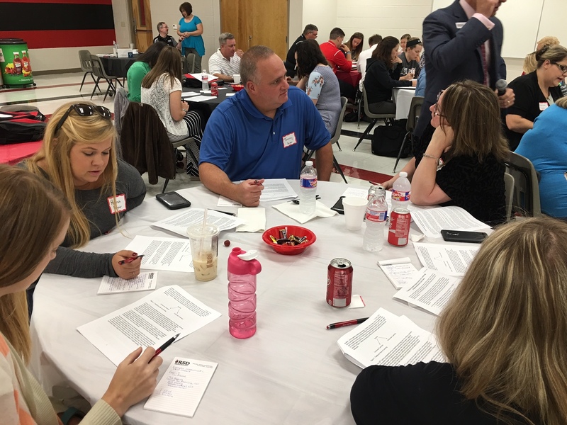 New teacher work together at a table during the New Teacher Academy.