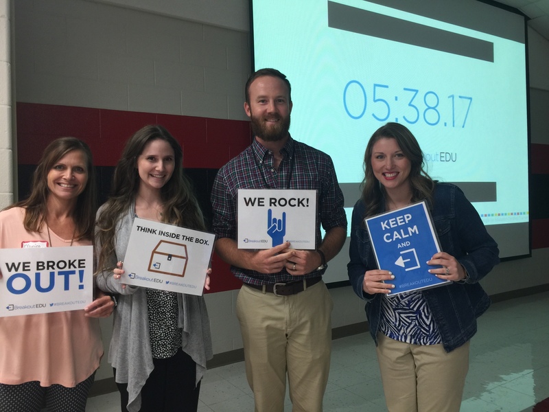 Four new teachers pose after completing the Digital Escape Room.