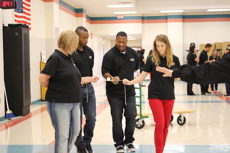 New teachers participate in a team building activity at new teacher academy.